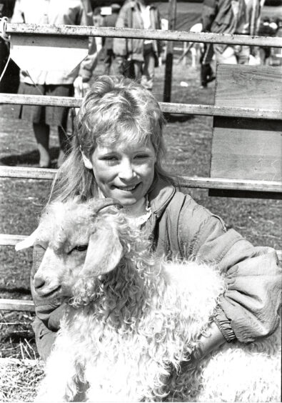 A young girl and a fluffy sheep at Turriff Show
