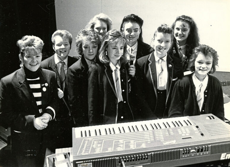 Students behind a keyboard with a microphone