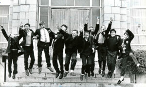 St Machar Academy pupils jumping on the stone steps outside the school