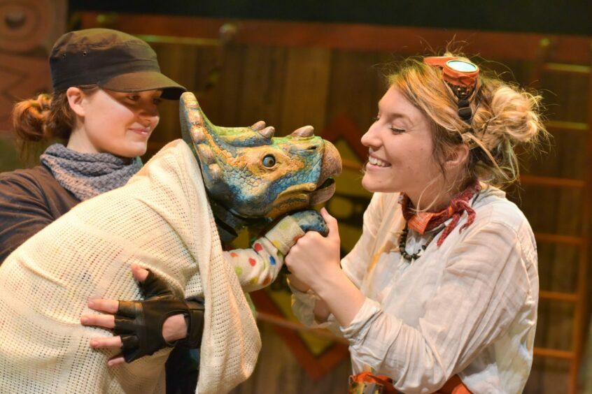 Cast members of Dinosaur World Live with a baby dinosaur puppet, which will be coming to Inverness