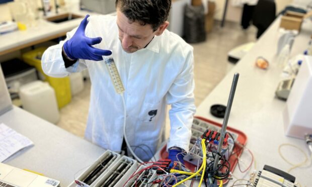 Dr Xavier Alexis Walter, a senior researcher in water and wastewater management in a circular economy at The James Hutton Institute in Aberdeen, feeding his experiment.