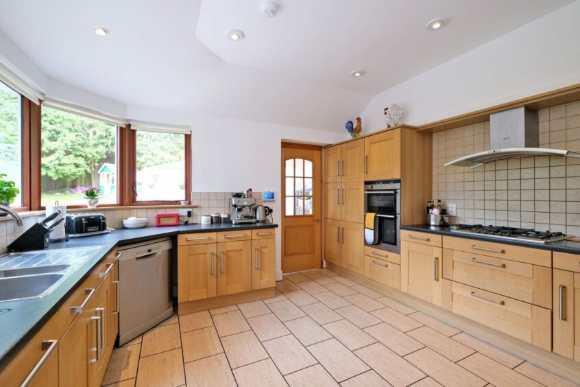 Large kitchen with an oak brown colour scheme.