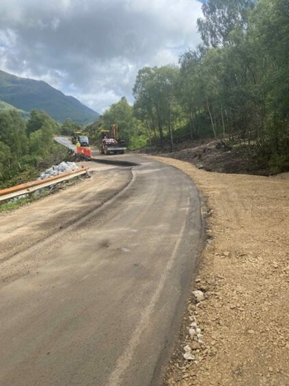 Diggers drive along the newly refurbished road.