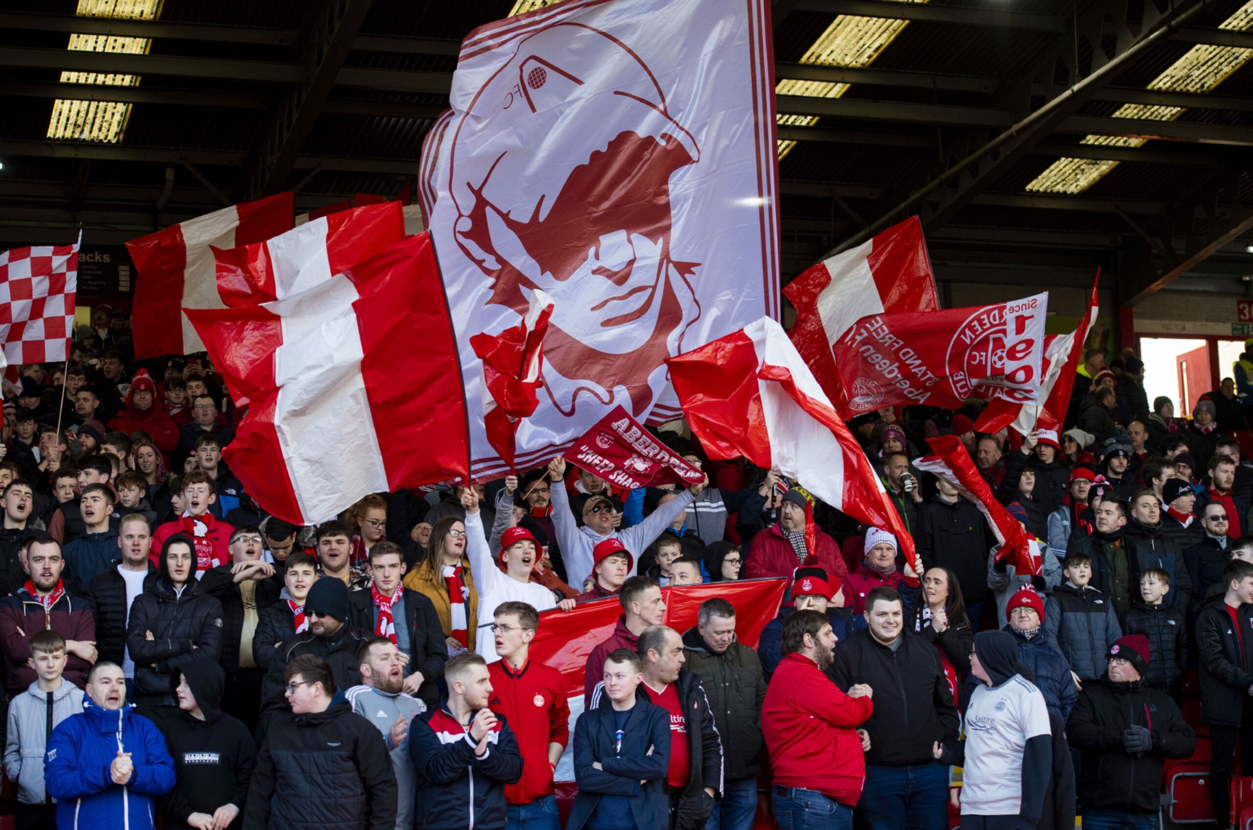 Aberdeen fans display flags ahead of kick off during the Scottish Cup 5th round tie between Aberdeen and Kilmarnock at Pittodrie Stadium on February 08, 2020. Image: SNS 