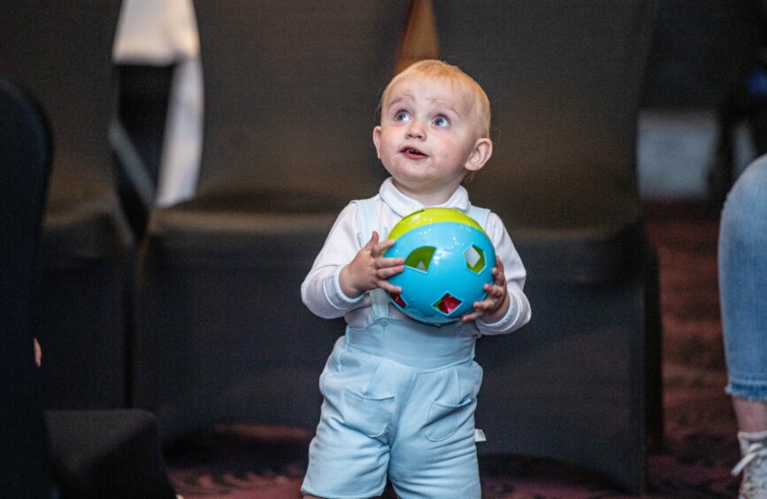 17-month-old boy holding a ball.