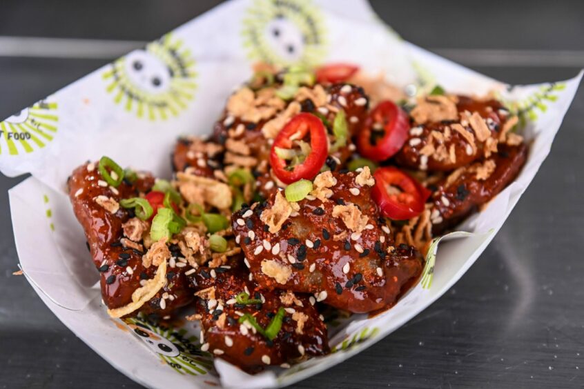 Korean fried chicken topped with sliced chillies and scallions at Moshi Moshi