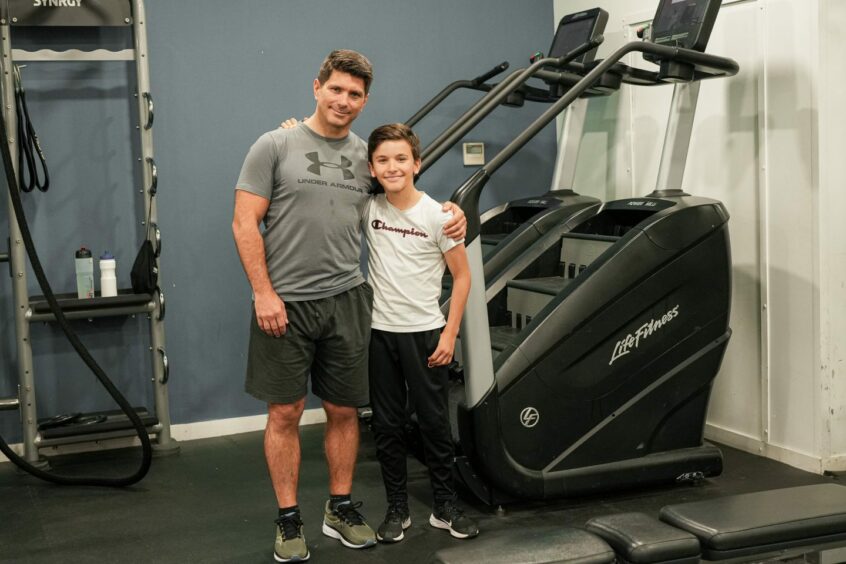 Filip Cegar standing with his dad Petar in the gym.