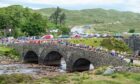 Runners make their way over the old bridge in Sligachan at the start of the Glamaig Hill Race. Image: Simon Riddell
