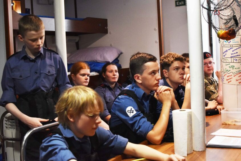 Cadets listening to training onboard The TS Royalist.