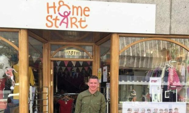 Scott Mackenzie standing outside Home-Start Aberdeen's charity shop.