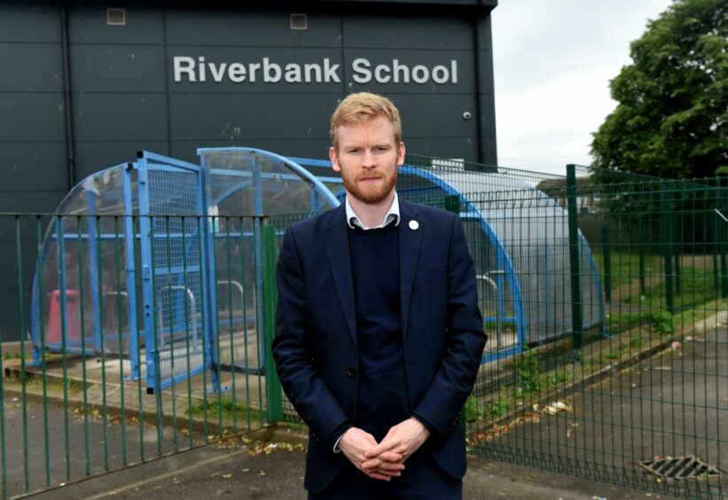 Labour councillor Ross Grant in front of Riberbank School.