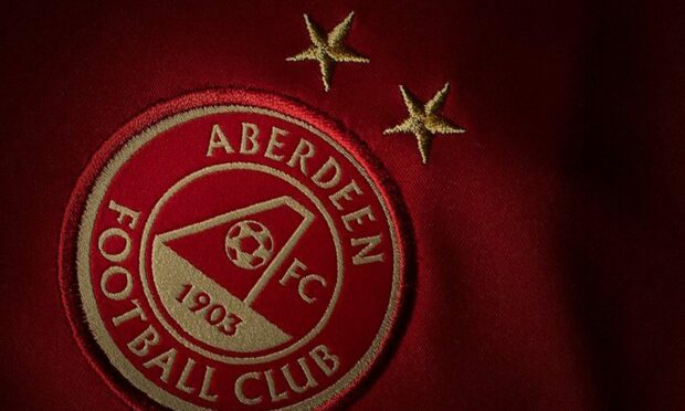 Close up teaser of gold crest on Aberdeen FC's new 2023/24 home kit.