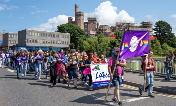Highland pride parade in front of Inverness castle.