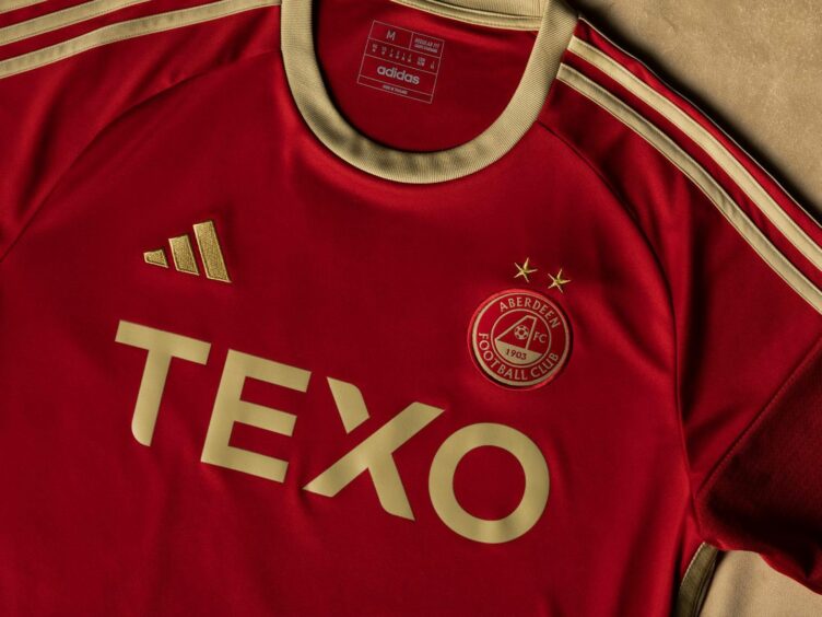 Close-up of the new Aberdeen FC home kit with a golden crest and stars.