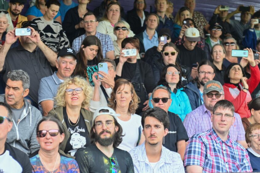 Onlookers taking pictures at the Inverness Highland Games 2023.