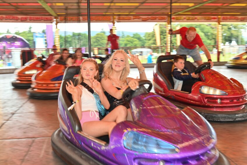 Young girls on the bumper cars at Belladrum Festival 2023.