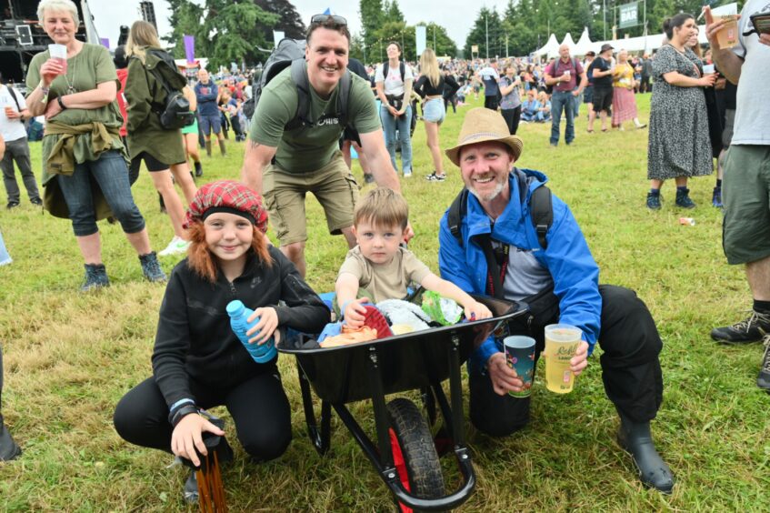 Man with child in wheelbarrow at SkerryVore.