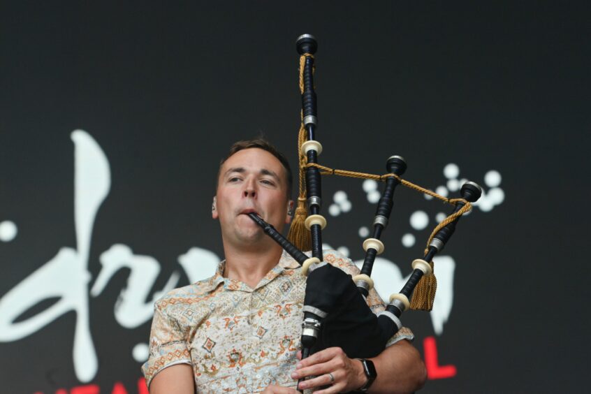 Skerryvore bagpiper on stage.