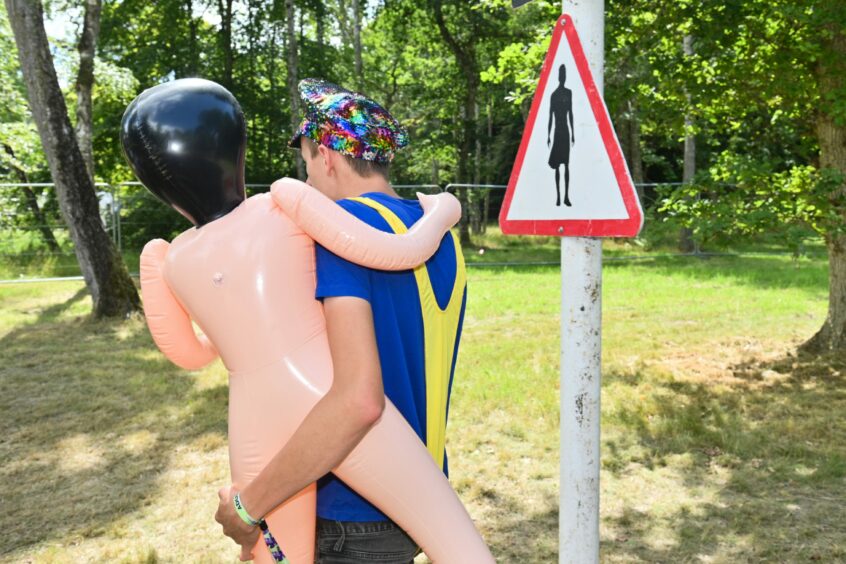 Reveller carrying a blow up doll.
