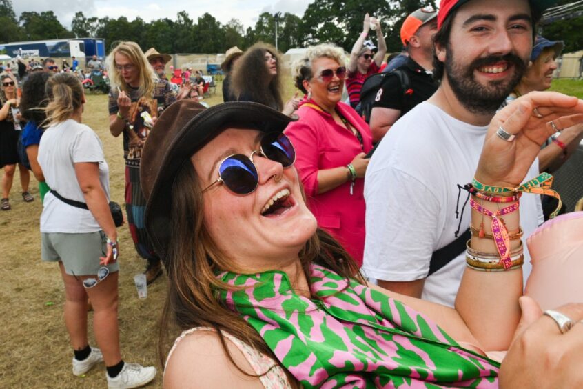 Woman laughs at festival.