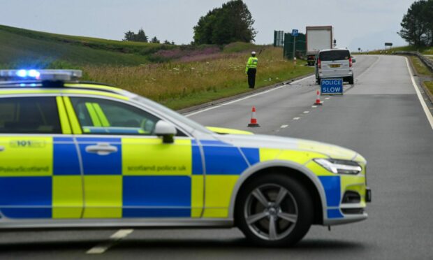 Police car parked across the A90 with a van on the road in the distance.