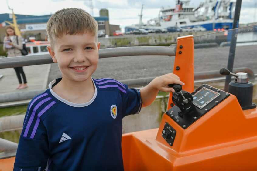 Boy smiles for pictures at the Peterhead Lifeboat open day.