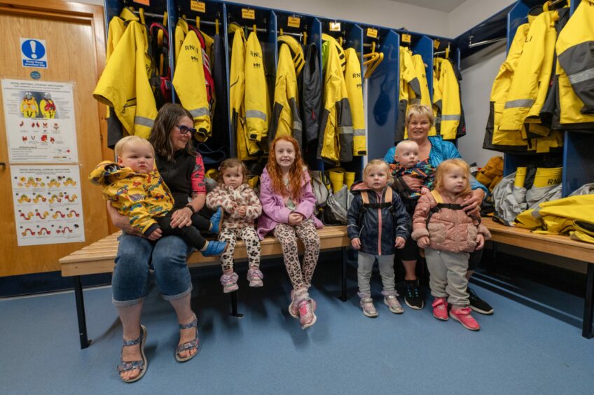 Young families take a tour around the Lifeboat station.