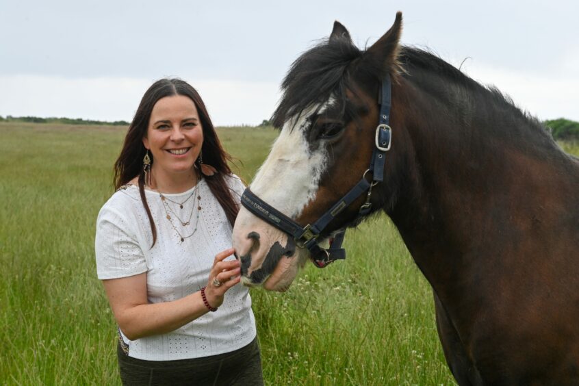 Susi with a horse in the Belhelvie countryside, where she has opened up a wellbeing hub.