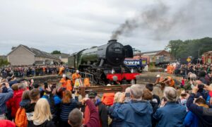The Flying Scotsman, with people standing watching.