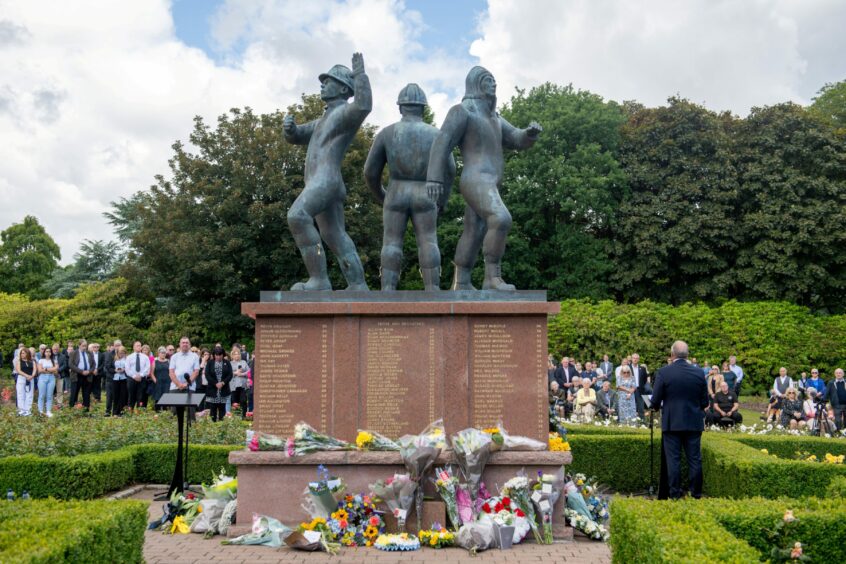 Wreaths around the Piper Alpha memorial statue.