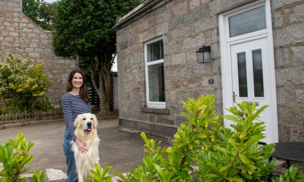 Katie McRobbie, pictured with her adorable pooch Macdui, has spent evenings and weekends renovating the traditional hone she will share with her partner Alistair Thomson. Image: Kath Flannery/DC Thomson