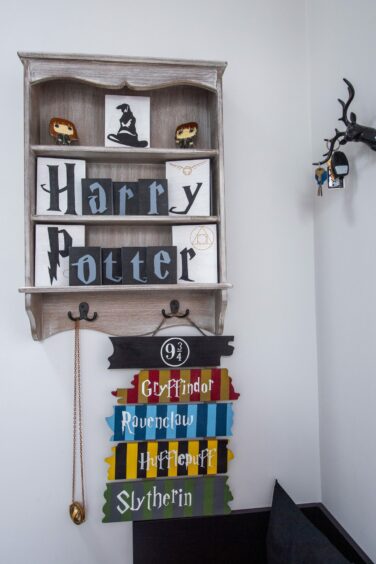 Shelf featuring Harry Potter themed decor.