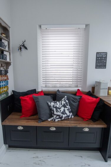 Utility room featuring stylish bench with clever storage drawers underneath.