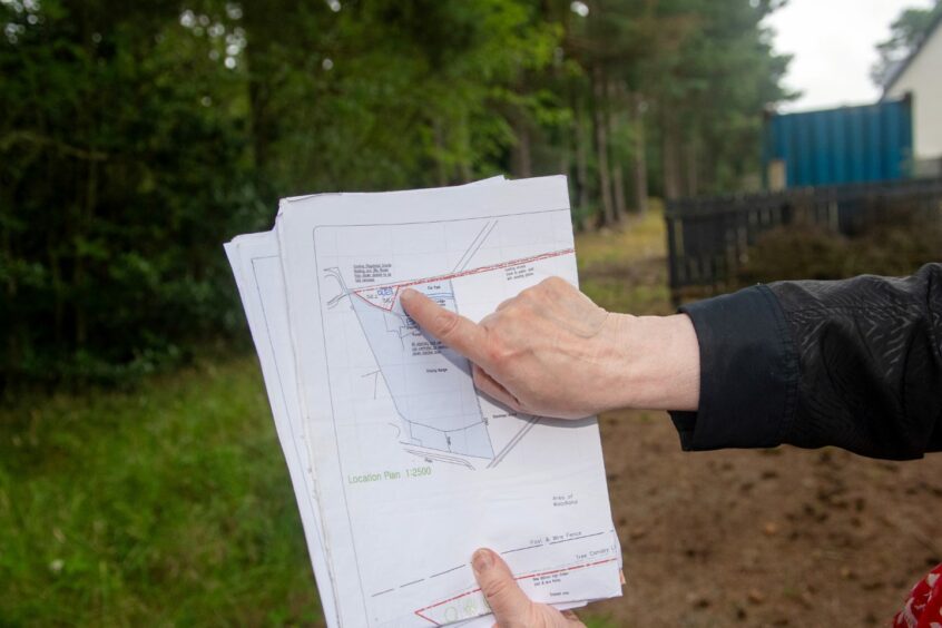 Janet Lees, who sold the land to the current owner, with maps of the area.