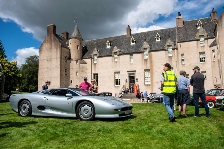 A classic car in front of Drum Castle.