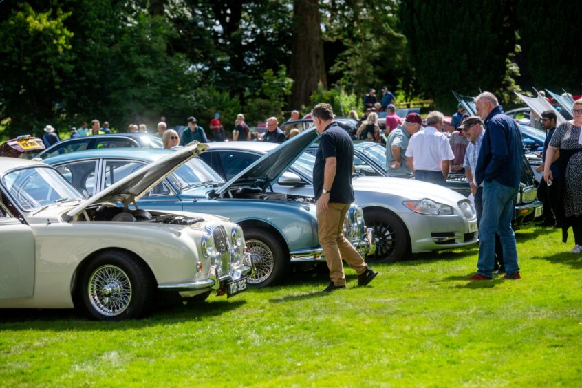 Crowds of people at the Drum Castle car show.