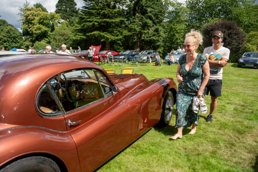 Car enthusiasts eyeing up the different vintage cars.
