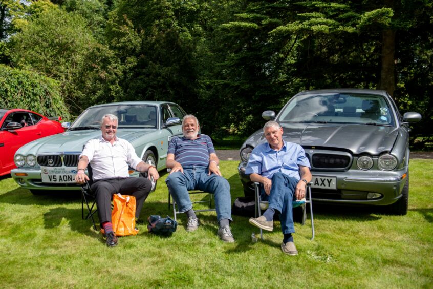 Group of attendees with their Jaguars the XJ308 and the XJ350.