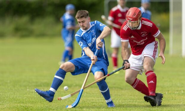 Kilmallie's Lewis Birrell, left, in action against Kinlochshiel. Image Neil Paterson