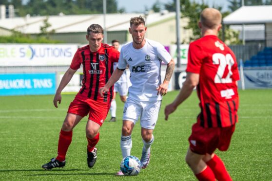 CR0043762 Callum Law story, Aberdeen. Connor Scully testimonial Cove Rangers v Fraserburgh. Cove's Mitch Megginson, centre, Fraserburgh's Grant Campbell, left, and Ross Aitken. Saturday 8 July 2023. Image: Kami Thomson/DC Thomson