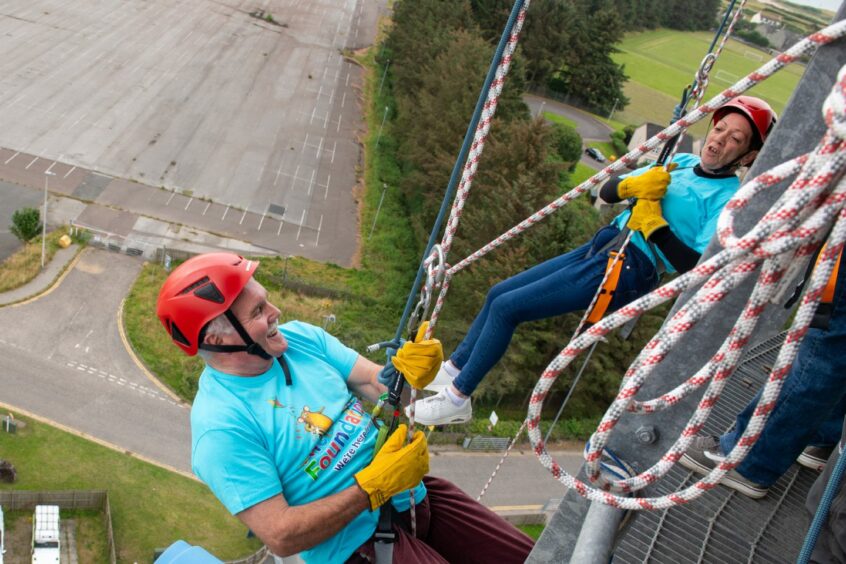 Jim Souter and Carole Duncan look at each other as they begin the abseil 