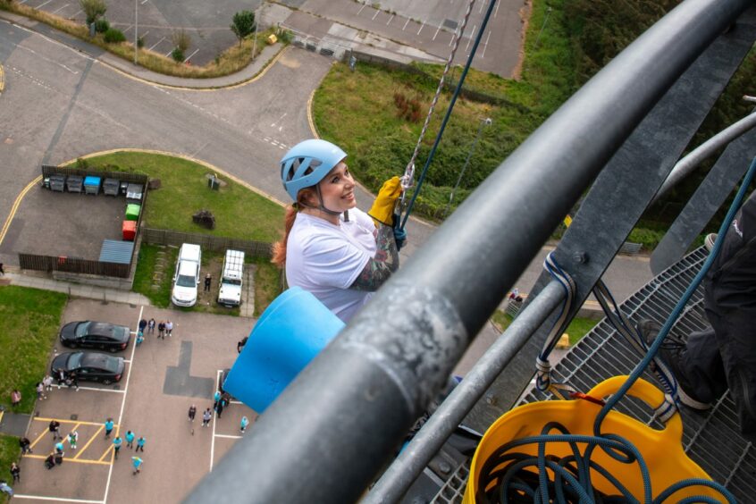 Becca Freestone starting her abseil challenge 