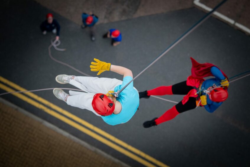 Caitlin Parkin and Jackie McIntyre photographed from above as they abseil 