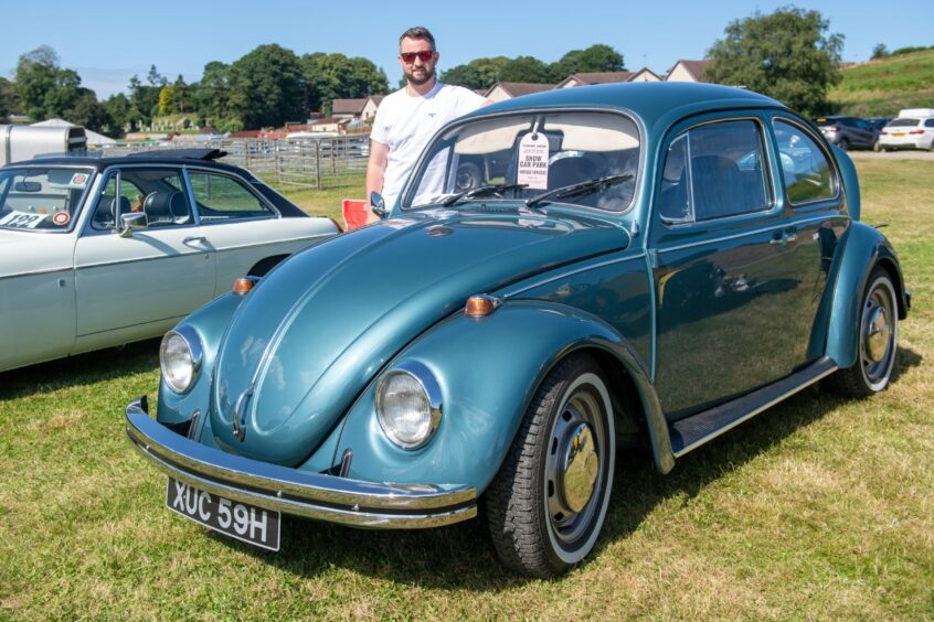 Stewart Hancock with his sistr Sarah's 1969 Volkswagen Beetle. 