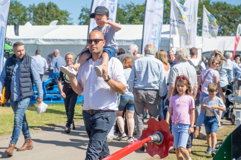 Man carrying son on shoulders. 