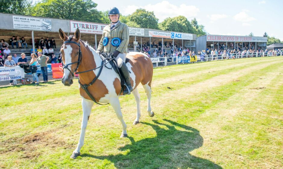 A horse and its rider at the show.