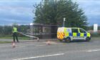 Police and a police van at the scene at Culloden