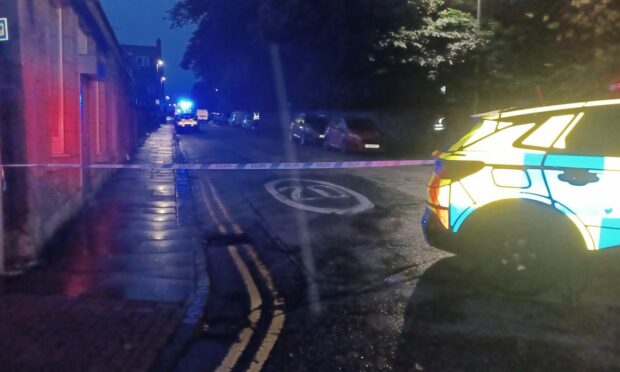 A police cordon was erected at the end of South Crown Street. Image: Chris Cromar/DC Thomson