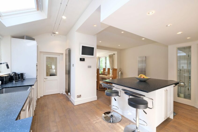 Minimalist kitchen with an island in the Morningfield Road property.