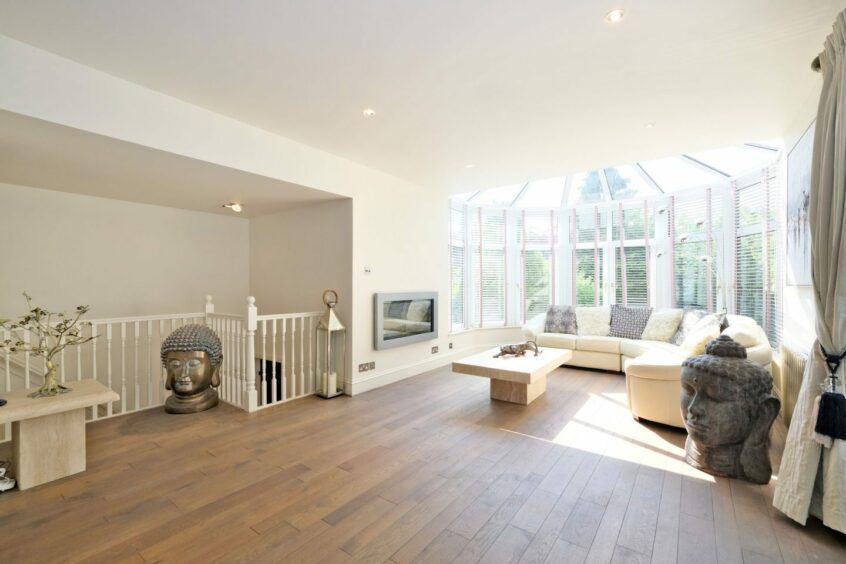Large family area with large bay windows and glass ceiling.